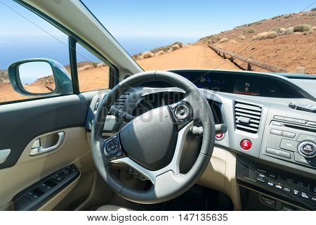 car windscreen with mountain ountry road, view inside out