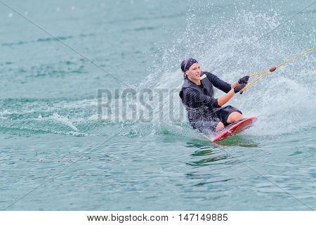 Young woman kneeboarding, toned image, horizontal image