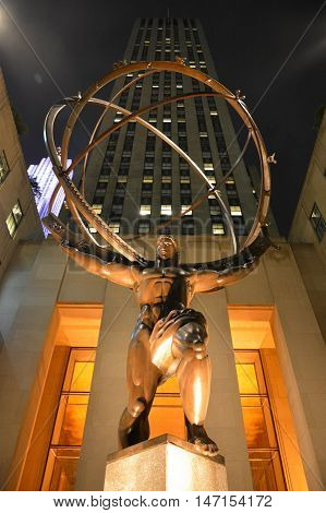 New York, United States of America - September 30, 2015. The statue of Atlas at the Rockfeller Center in New York City, at night, with Rockfeller Center in the background.