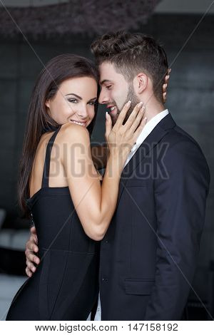 Stylish milf woman touch young lovers face sensual couple indoors