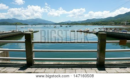 Boats, Pier, Lake And The White Cloud In Sunny Day