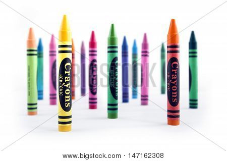 Vertical positioning wax crayons on white background
