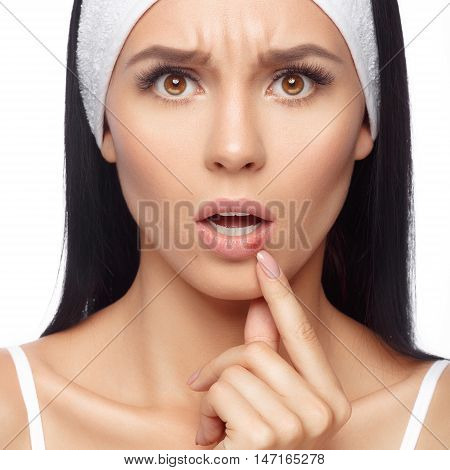 Herpes on the lips of the young woman. Shocked young woman touching pain her lips. Inflammation of the lip. Herpes on the lips, beauty concept. Woman with herpes virus. Woman Skin Care Concept