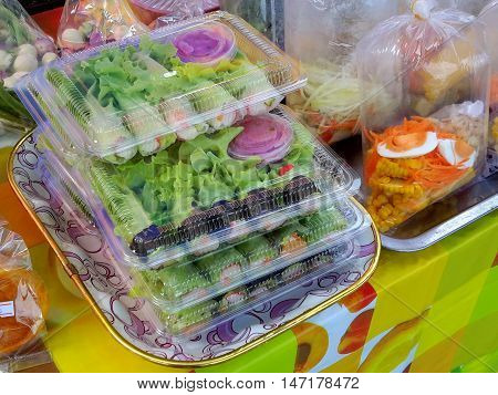 fresh homemade leafy green and egg salads for sale at a market in Ranot, Thailand