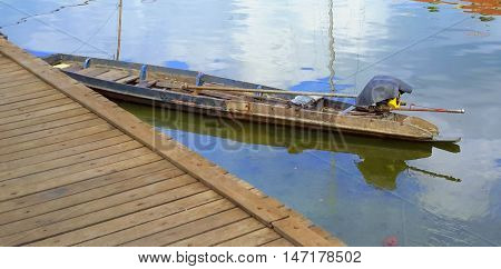 Thai longtail boat tied up at the dock, river water market at Ranot, Thailand