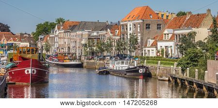 ZWOLLE, NETHERLANDS - AUGUST 31, 2016: Panorama of a canal with old ships and historical houses in Zwolle, Netherlands