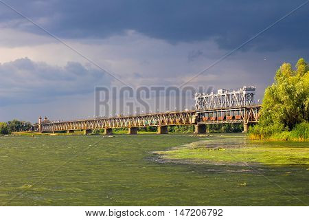 Bridge across river Dnieper in Kremenchug and storm clouds in sky