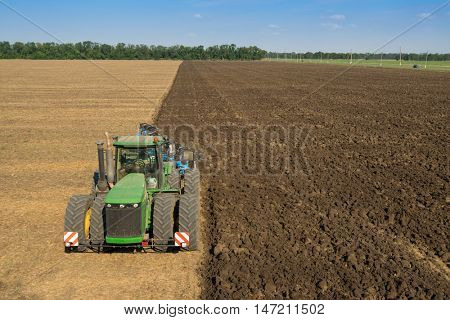 KRASNODAR REGION, RUSSIA - AUG 19, 2015: Tractor plows field, In 2015 in Krasnodar region yields reached record level - 58.4 centners per hectare