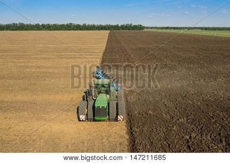 KRASNODAR REGION, RUSSIA - AUG 19, 2015: Modern tractor plows field, In 2015 in Krasnodar region yields reached record level - 58.4 centners per hectare