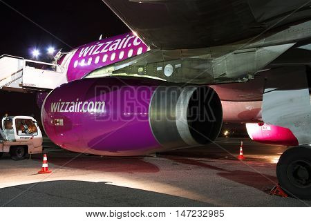 Kiev Ukraine - March 27 2011: Wizz Air Airbus A320 engine closeup - plane is being serviced at night in the airport
