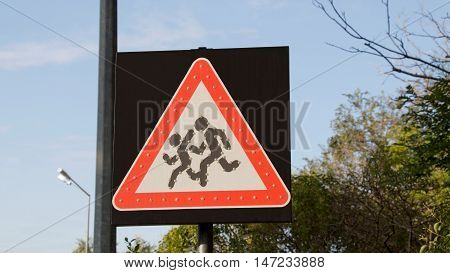 Road sign people run across the road