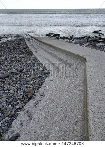 Stepped jetty rocky beach seascape photographed at Amroth in Pembrokeshire