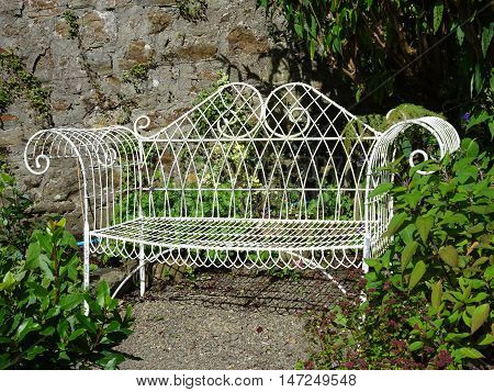 Ornate pathway bench photographed at Colby Woodland Garden near Amroth in Pembrokeshire