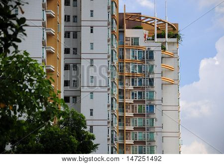 Apartment buildings against a blue sky within the city of Guangzhou China in Guangdong province.