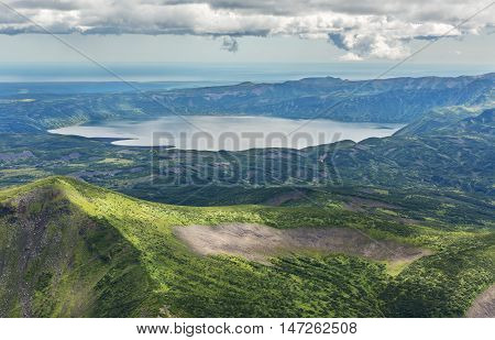 Crater Karymsky Lake. Kronotsky Nature Reserve on Kamchatka Peninsula. View from helicopter.