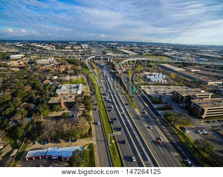 Aerial Austin Over Highway 183 on a nice sunny morning in Austin , Texas with interchange and loops in the distance and cars driving during traffic rush hour