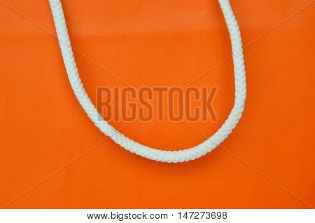orange paper bag and white nylon handle