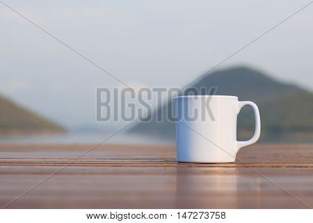Coffee cup with river and mountain (vintage background)