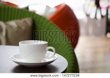 Coffee cup on table in cafe (vintage background)