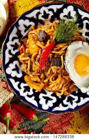 Asian Style Noodles with Meat and Laghman Sauce. Garnished with Fried Egg