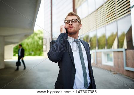 Businessman caling outdoors