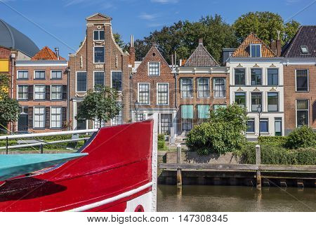 Bow of a red ship and historical houses in Zwolle Netherlands
