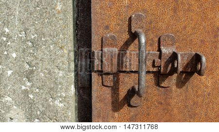 rusty iron door with deadbolt close to