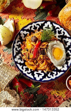 Asian Style Noodles with Meat and Laghman Sauce. Garnished with Fried Egg