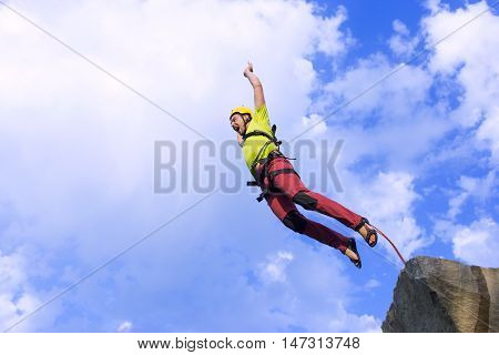The first jump off the cliff with a safety rope.
