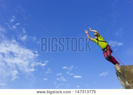 The first jump off the cliff with a safety rope.