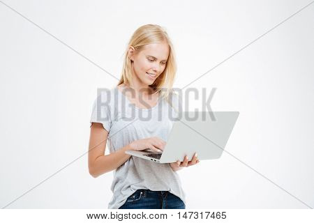 Portrait of a happy woman using laptop computer isolated on a white background
