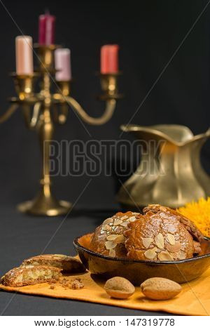 Typical Dutch filled spicy cookies with almonds on autumn colored and dark background