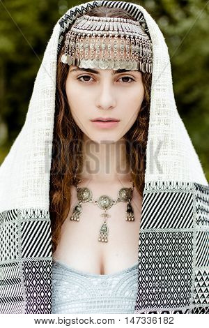 Young girl in traditional folk Crimean Tatar clothes walking in fields