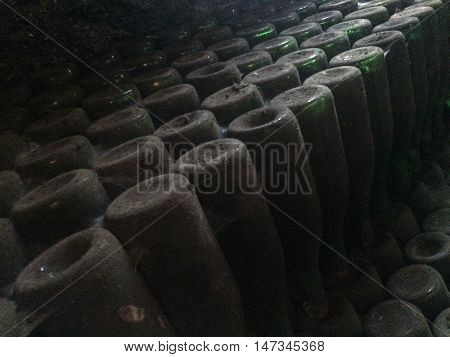 Dark cellar with old bottles of red wine