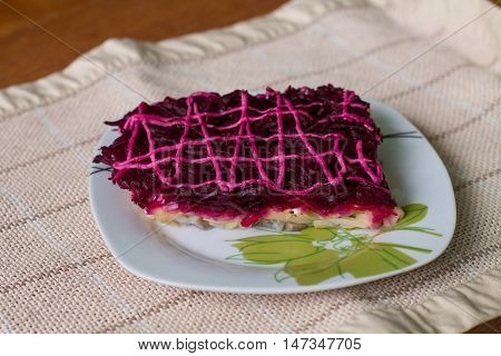 Dressed herring (Ukrainian: Shuba) is a layered salad composed of diced salted herring covered with layers of grated boiled vegetables (potatoes, carrots, beet roots), chopped onions, and mayonnaise.