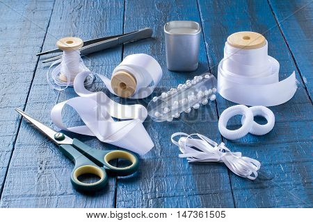 Making beautiful bows for decoration hair and gifts in the art kanzashi. Step by step photo instructions. Step 1. Preparation of materials (tape rubber barrettes) and tools (scissors tweezers)
