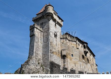 Ancient castle Liechtenstein donjon Vienna woods village Maria Enzersdorf Austria - against bright blue sky