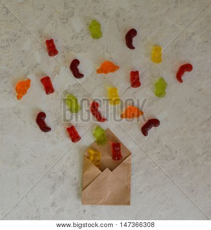 Colorful eat gummy bears jelly candy background. Bears in envelope