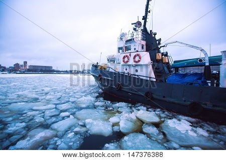 The Icebreaker Ship Trapped In Ice Tries To Break And Leave The Bay Between The Glaciers