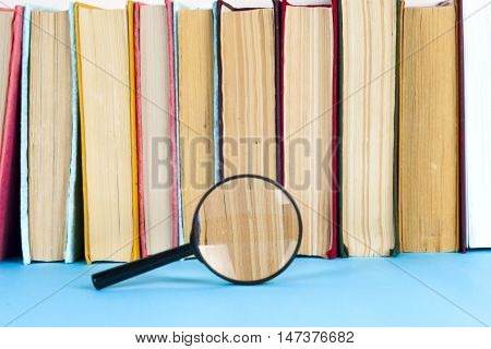 composition with book and magnifying glass. Back to school copy space. Education background.