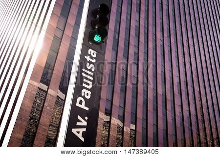 Traffic Lights with Paulista Avenue Sign in Front of the Building Facade
