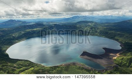 Crater Karymsky Lake. Kronotsky Nature Reserve on Kamchatka Peninsula. View from helicopter.