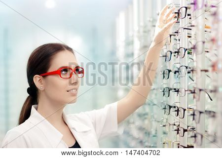 Happy Optician Choosing Between Eyeglasses Frames in Optics Shop