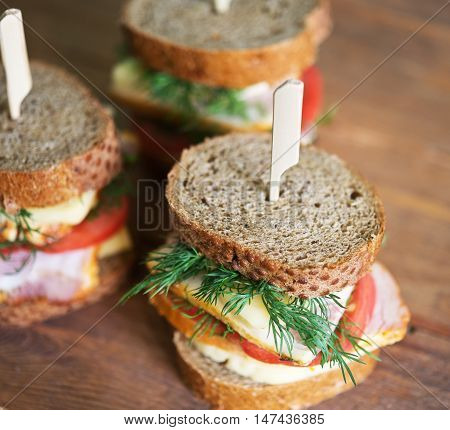 sandwiches with cheese carbonade tomato on a wooden table