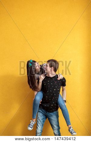 Inlove Couple Looking At Each Other On Yellow Wall