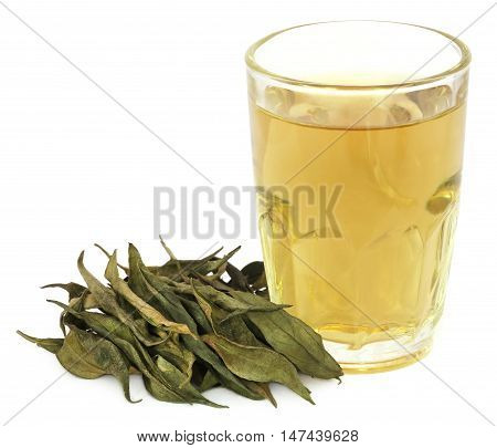 Ayurvedic medicinal Chirata with herbal juice in a glass