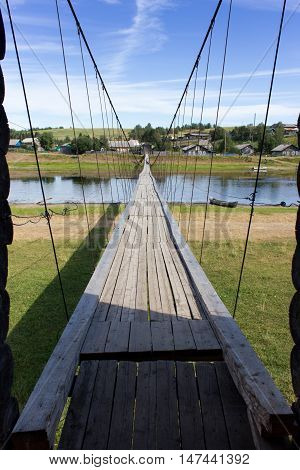 Rural Landscape At Summer With Wooden Suspension Bridge