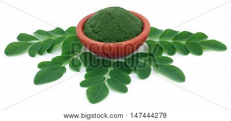 Edible moringa leaves with ground paste in a pottery