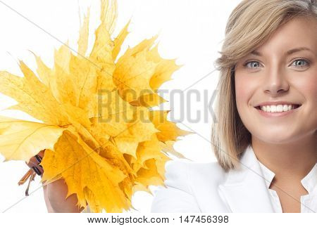 portrait of attractive  caucasian smiling woman isolated on white studio shot looking at camera hand holding yellow marple autumn leaves