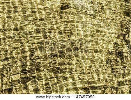 water texture pattern backgroundgold water in sea on morning time